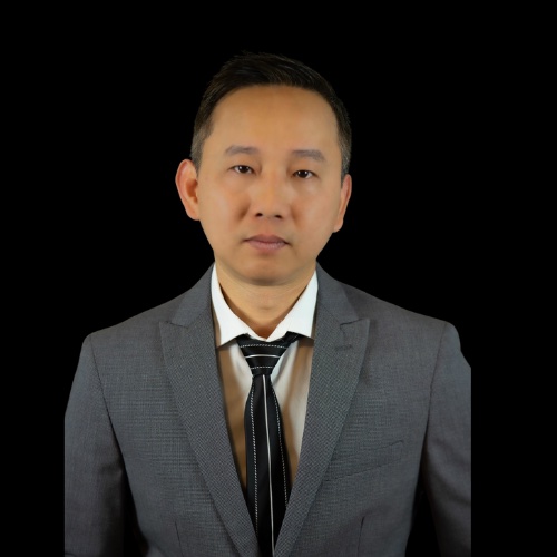 Grace Thoothman, salesperson at Mountain Ridge Realty, LLC. , wearing a splotchy white dress with blue and red paint swath designs.