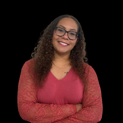 Kristen Schweiss, salesperson at Mountain Ridge Realty, LLC. , wearing a green shirt with white pants.